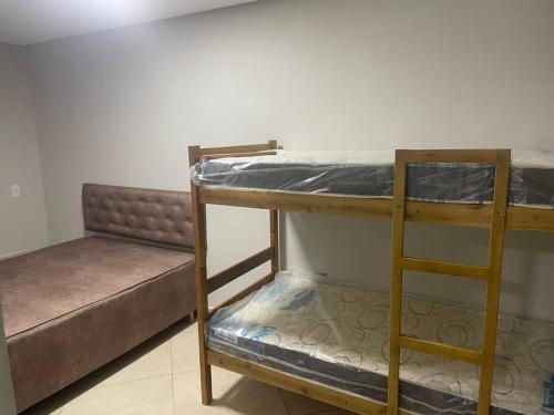 a couple of bunk beds in a room at Sol-v-mar in Penha