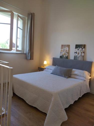 a bedroom with a large bed with a window at BEE HOME in Luni