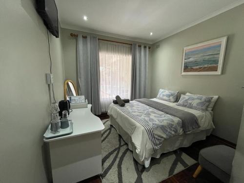 a hotel room with a bed and a window at Just B Zone Guest House in Johannesburg
