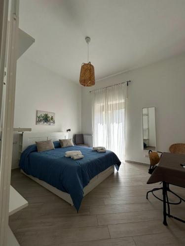 a bedroom with a blue bed in a white room at Luna's Apartment in Sant'Agnello