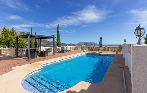 a large swimming pool with a gazebo next to at 2 Bedroom Lovely Home In Orba in Orba