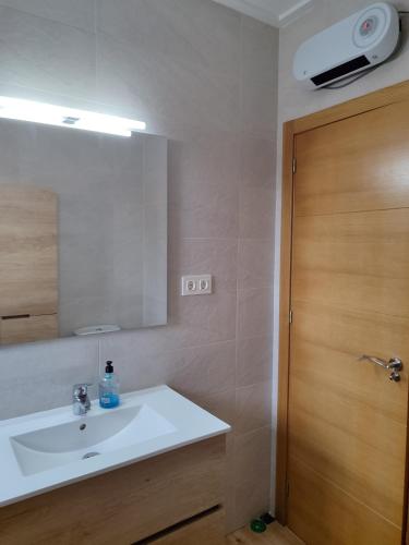 a bathroom with a white sink and a mirror at VILLA ALTO DE LOS BALCONES Torrevieja - Orihuela Costa in Orihuela Costa
