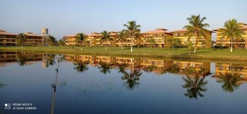 a view of the resort from across the water at Villa das águas in Estância