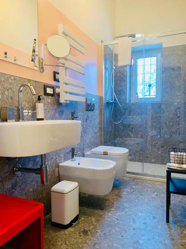 a bathroom with a sink and a toilet and a shower at UnPazzoIndietro in Monopoli