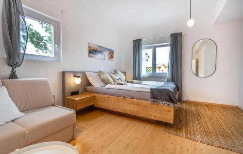 a bedroom with a bed and a couch and a window at Stunning Apartment In Izola With 1 Bedrooms, Wifi And Outdoor Swimming Pool in Izola