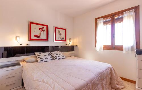 a bedroom with a large bed and a window at 2 Bedroom Lovely Home In Orba in Orba