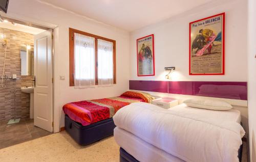 a bedroom with two beds and a bathroom at 2 Bedroom Lovely Home In Orba in Orba