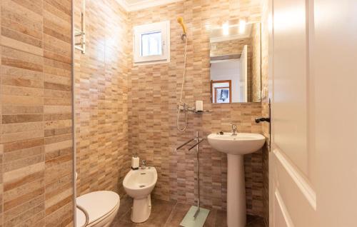 a bathroom with a toilet and a sink and a shower at 2 Bedroom Lovely Home In Orba in Orba