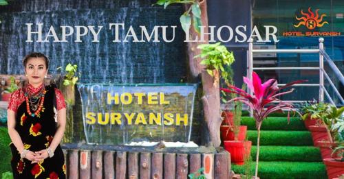 a woman is standing in front of a hotel at Hotel Suryansh Pvt Ltd in Heṭauḍā