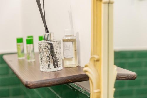 a wooden shelf with two bottles on it at [Centro Storico] Redmood House a 5 min dal mare, Wi-Fi, A/C e Netflix in Barletta