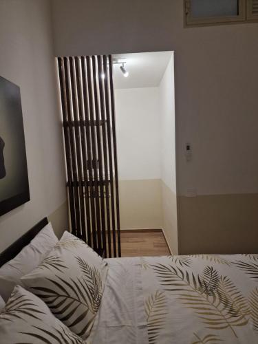 a bedroom with a bed and a wooden chair at DoMa house b&b in Nocera Inferiore