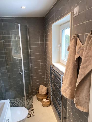a bathroom with a shower and a sink at Stockholm Archipelago House with shared pool in Mörtviken