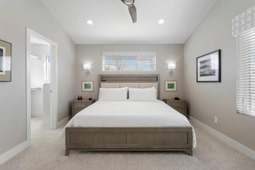 a bedroom with a large bed with white sheets at Luxury Home: Monthly Rental House Near Denver in Englewood