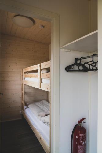 a bunk bed in a wooden room with at Skógsnes II in Selfoss