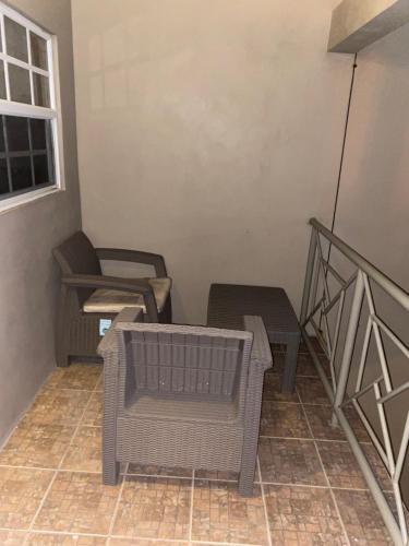 a balcony with chairs and tables and a window at Cozy one bedroom apartment in Lambeau