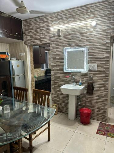 a kitchen with a sink and a table with a table at Chandigarh Housing Board Flats Sector 44 D in Chandīgarh