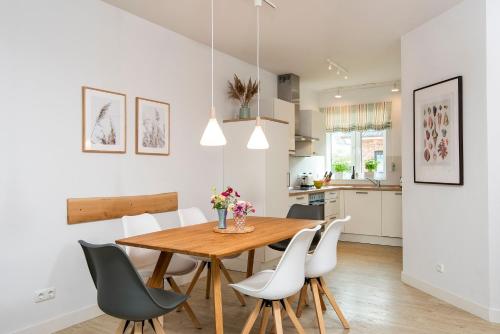 a kitchen and dining room with a wooden table and chairs at Alte Waescherei _9463_ in List