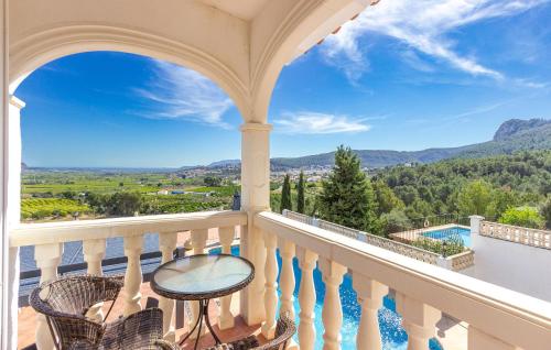 a balcony with a view of a pool and mountains at 2 Bedroom Lovely Home In Orba in Orba