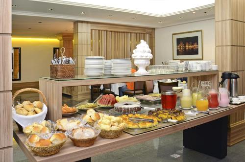 a buffet with many different types of food on a table at Castel Plaza Hotel in Resende