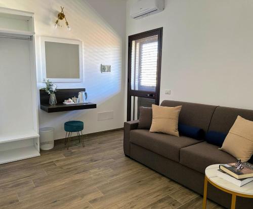 a living room with a couch and a table at Villa Azzurra in Lampedusa