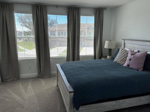 a bedroom with a bed and a large window at New Luxury Townhome, Stay close in style! in Davenport