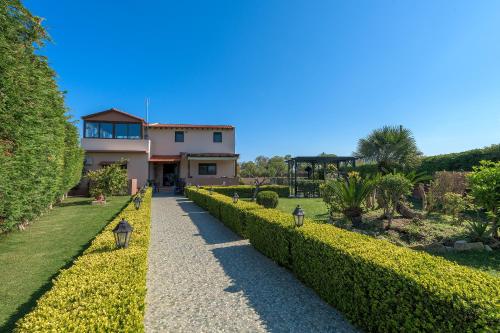 a house in the middle of a garden at Villa Vera in Paradeísion