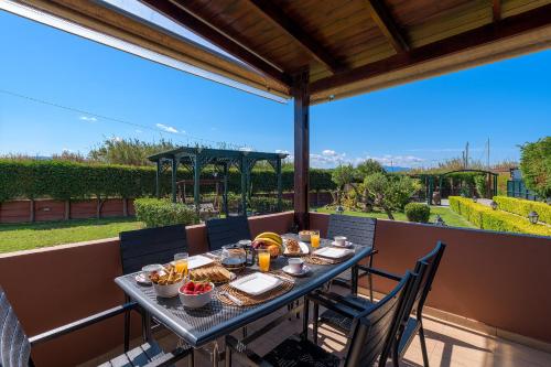 a table with food on it on a patio at Villa Vera in Paradeísion
