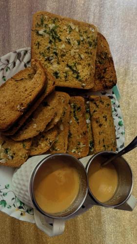 a plate with bread and two cups of peanut butter at Hotel Raghunath Residency Niwas in Shirdi