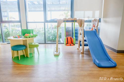 a play room with a slide and a table at 56sqm 2BR Condo at Mactan Newtown Pool and Beach Access! in Lapu Lapu City