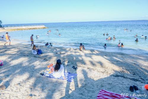 a group of people in the water at a beach at 56sqm 2BR Condo at Mactan Newtown Pool and Beach Access! in Lapu Lapu City