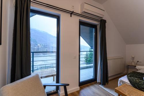 a bedroom with a large window with a view at Doftana Lake House in Teşila
