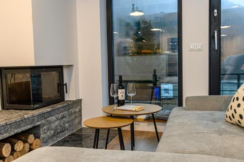a living room with a couch and a fireplace at Doftana Lake House in Teşila