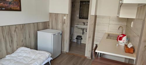 a small room with a refrigerator and a table at Apartmán 2 Hradná 9 in Nové Zámky