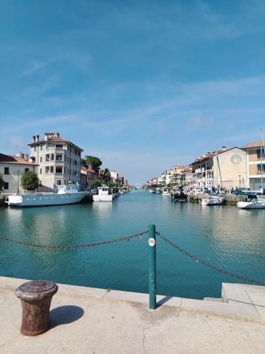 a view of a river with boats in a city at Irma in Grado