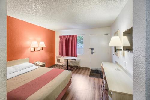 a hotel room with a bed and a desk and a window at Motel 6-Everett, WA - South in Everett