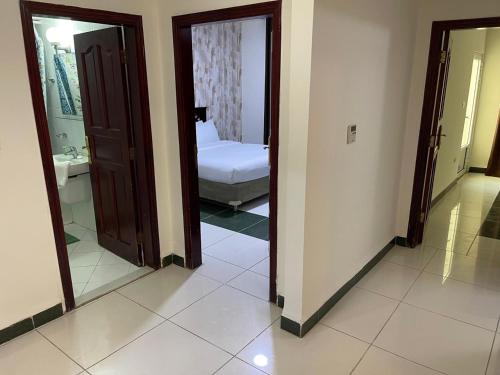 a room with a bedroom with a bed and a mirror at أجنحة أبو قبع الفندقيةAbu Quboh Hotel Suite Apartment in Amman