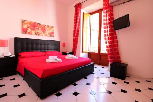 a bedroom with a red bed and a window at Estate4home - Sorrento Hearts in Sorrento