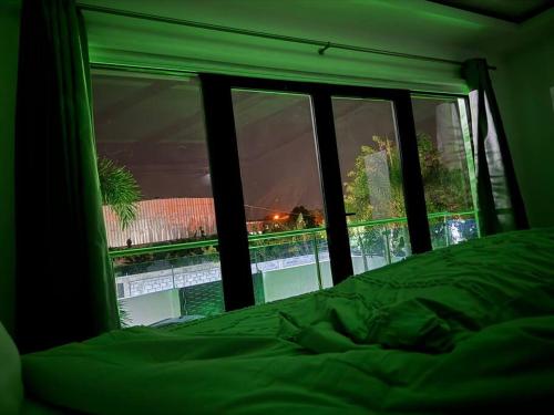 a bedroom with a window looking out at a pool at La Vega City home with pool in Concepción de La Vega