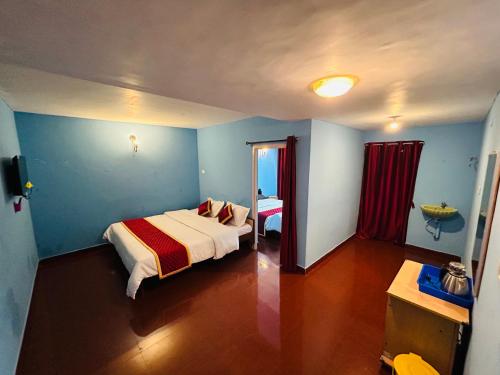 Un dormitorio con una cama y una mesa. en Dream Ville Homestay en Kodaikānāl
