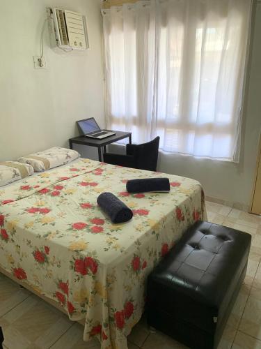 a bedroom with a bed with a table and a chair at Quarto confortável perto de tudo 03 in Belém