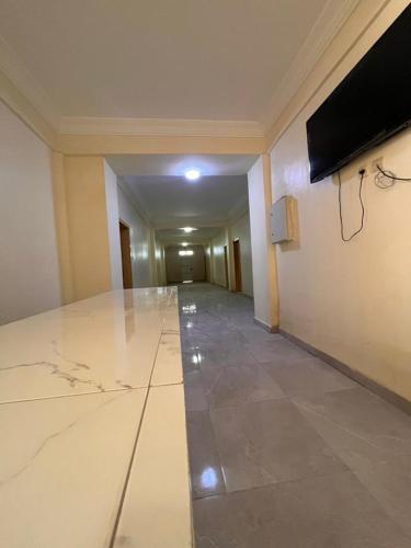 a hallway of a building with a large marble floor at Chaaban Department in Nouadhibou