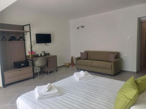 a living room with a bed and a couch at Domo Annalisa in Tortolì