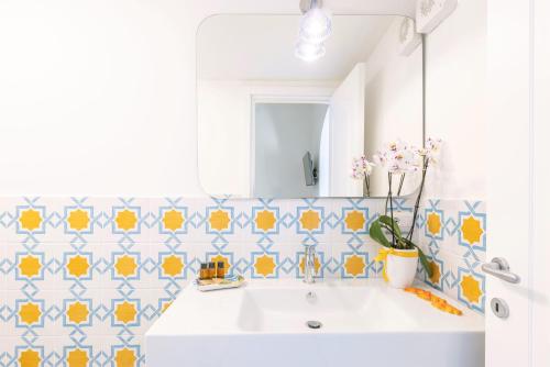 a bathroom with a sink and a mirror at YourHome - Adoro Positano in Positano