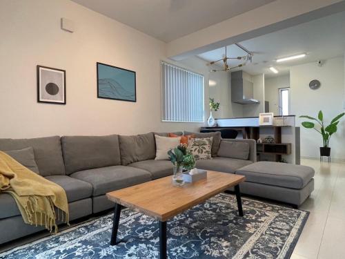 a living room with a couch and a table at Casa YONNA Miyakojima in Miyako-jima
