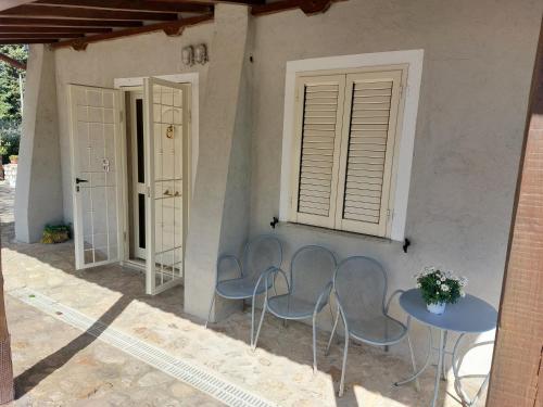 a patio with two chairs and a table and two doors at Casa civico22 in Fratta Todina