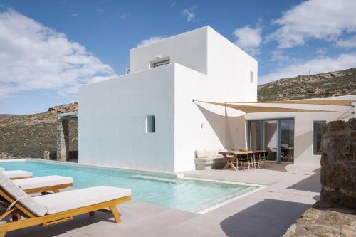 a white villa with a swimming pool and a house at Retreat Hill Luxury Villas Mykonos in Mýkonos City