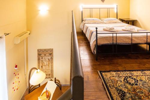 a bedroom with a bed and a table with a lamp at Hola House alla Kalsa in Palermo