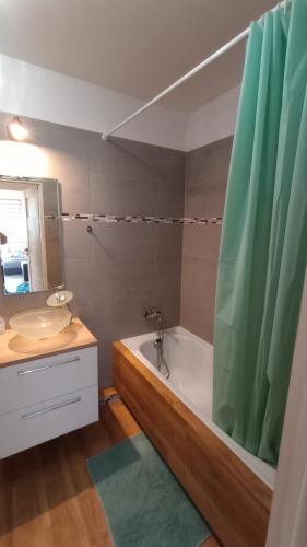 a bathroom with a tub and a sink and a shower at Odkryta Warszawa! - Private studio balcony, free wifi, tv, parking, self check in - Warsaw North in Warsaw