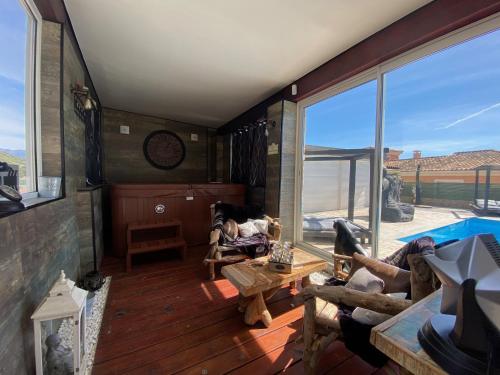 a living room with a view of a pool at Chambres du Gozzi in Afa