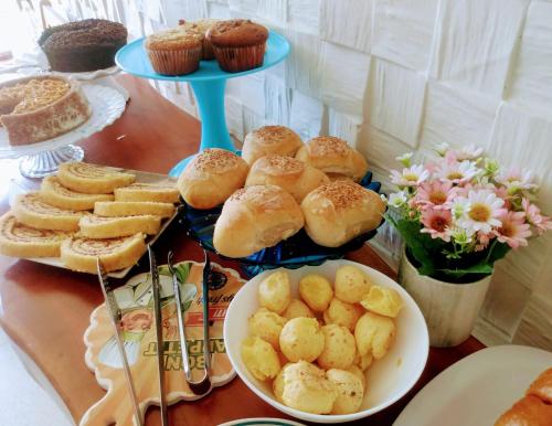 a table topped with plates of pastries and cupcakes at Mar Turquesa Eco Pousada in Maragogi
